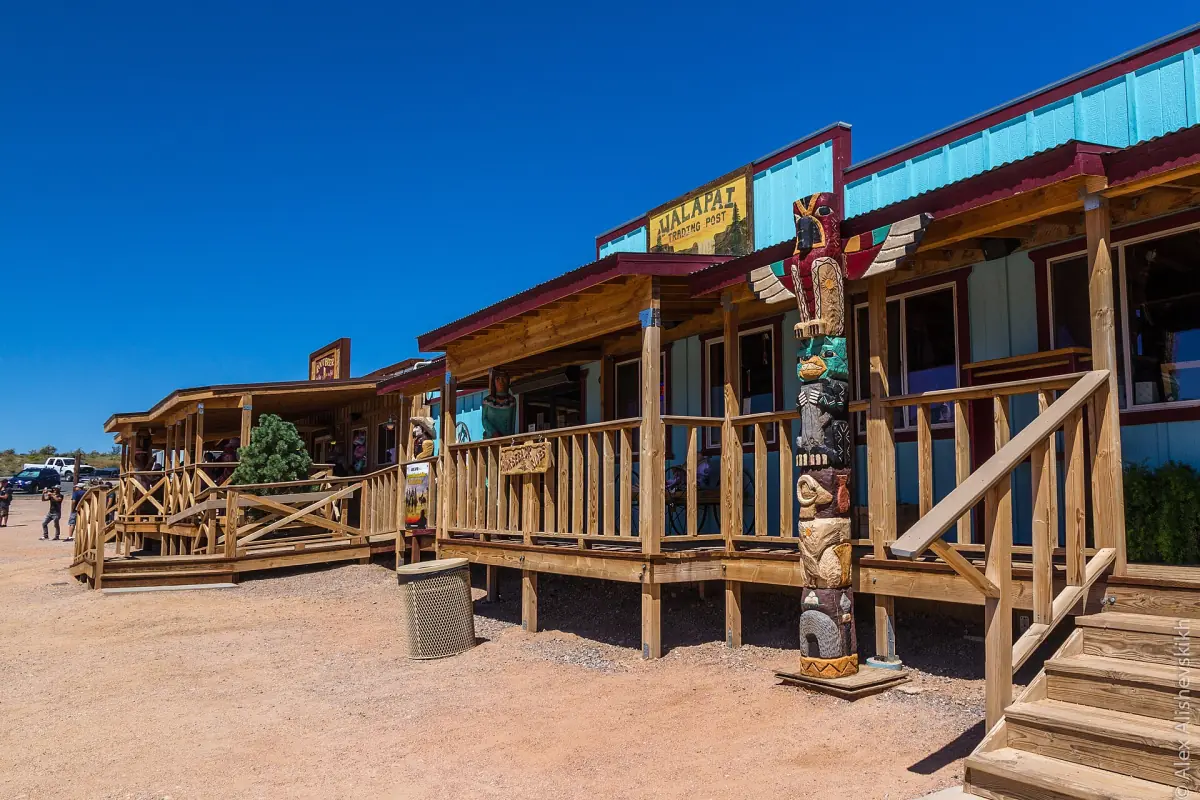 Western-style wooden buildings with a long porch at Hualapai Ranch