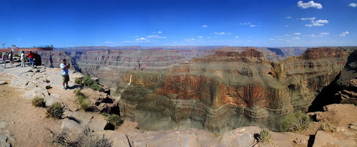 Wide view of the Skywalk platform and canyon under a deep blue sky