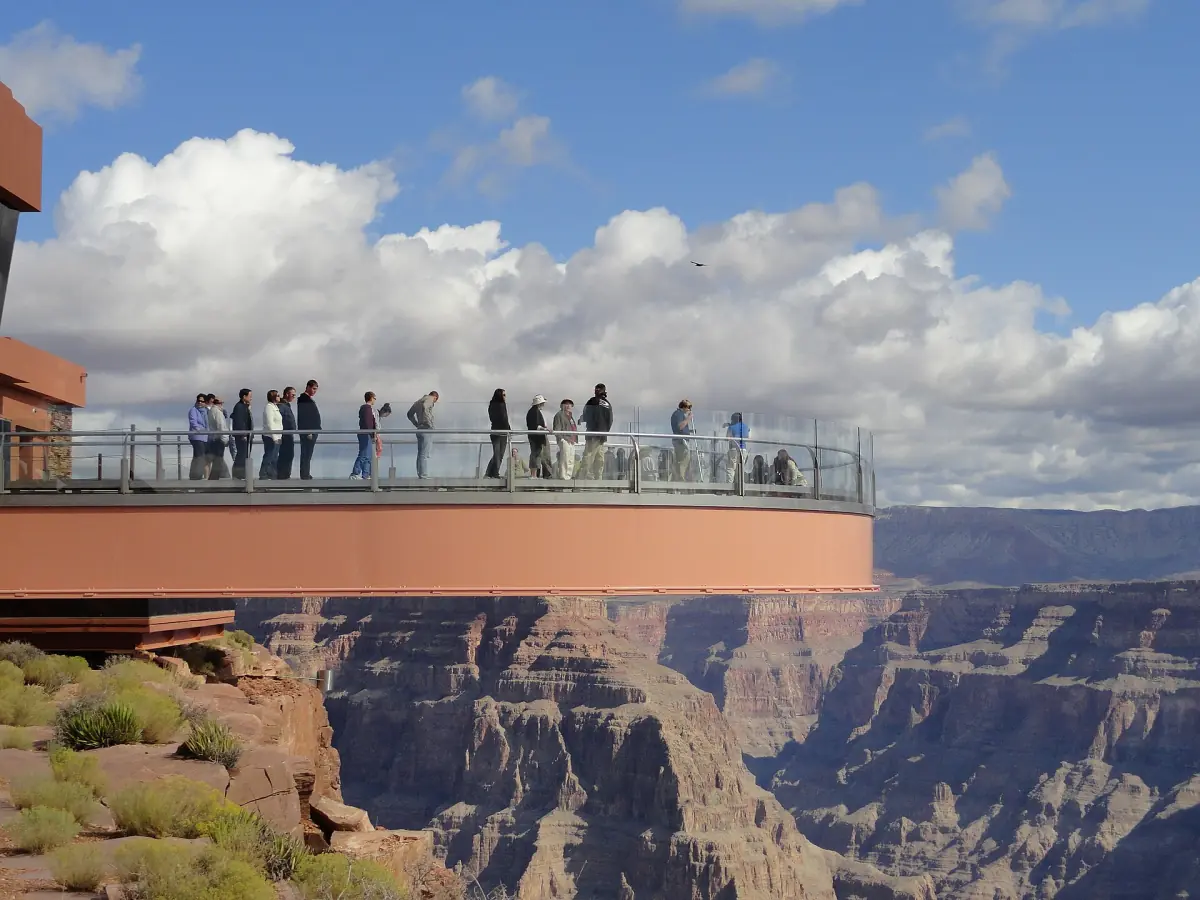 Horseshoe-shaped Skywalk glass bridge extending over the canyon with visitors on it
